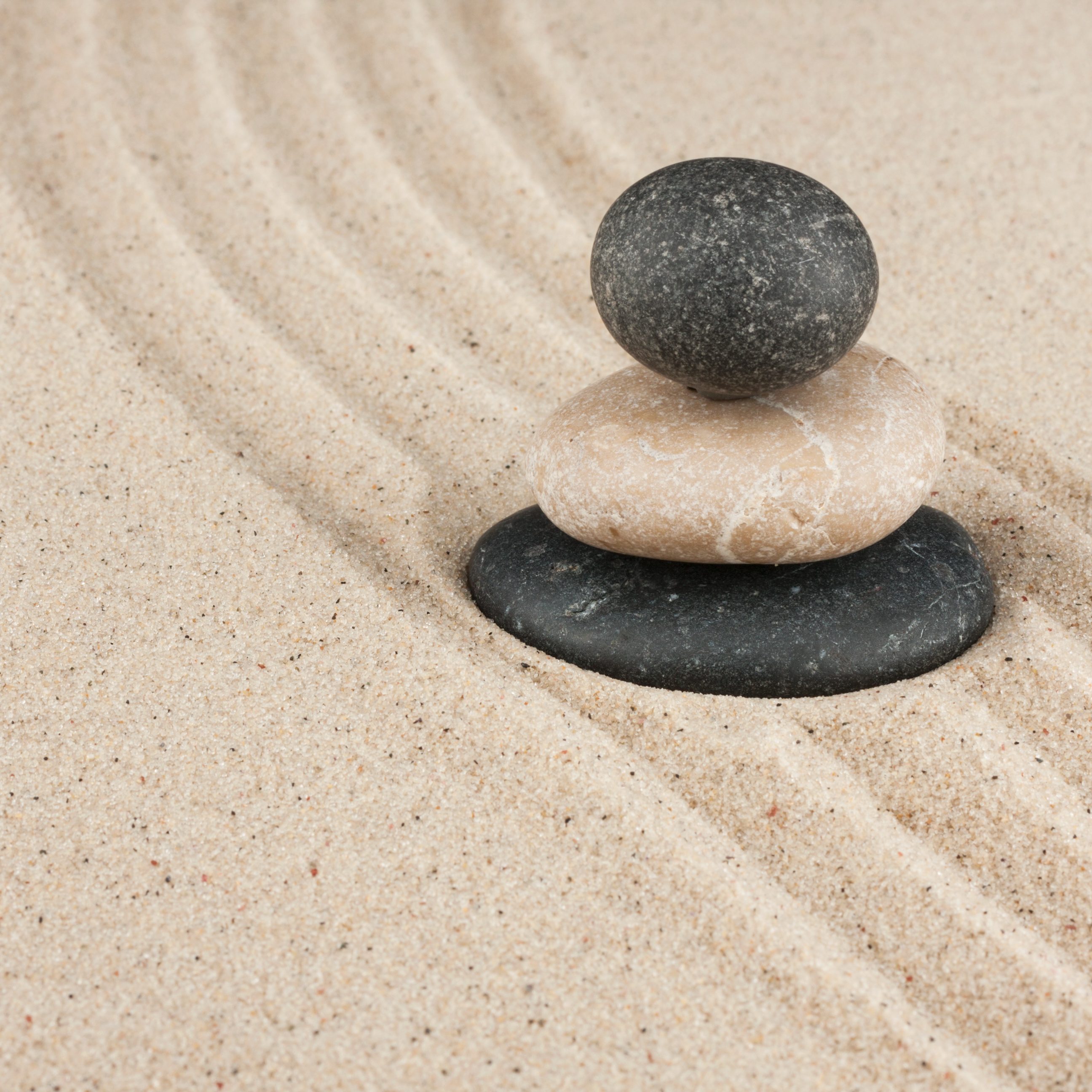 Pyramid made of stones standing on the sand, with space for your text